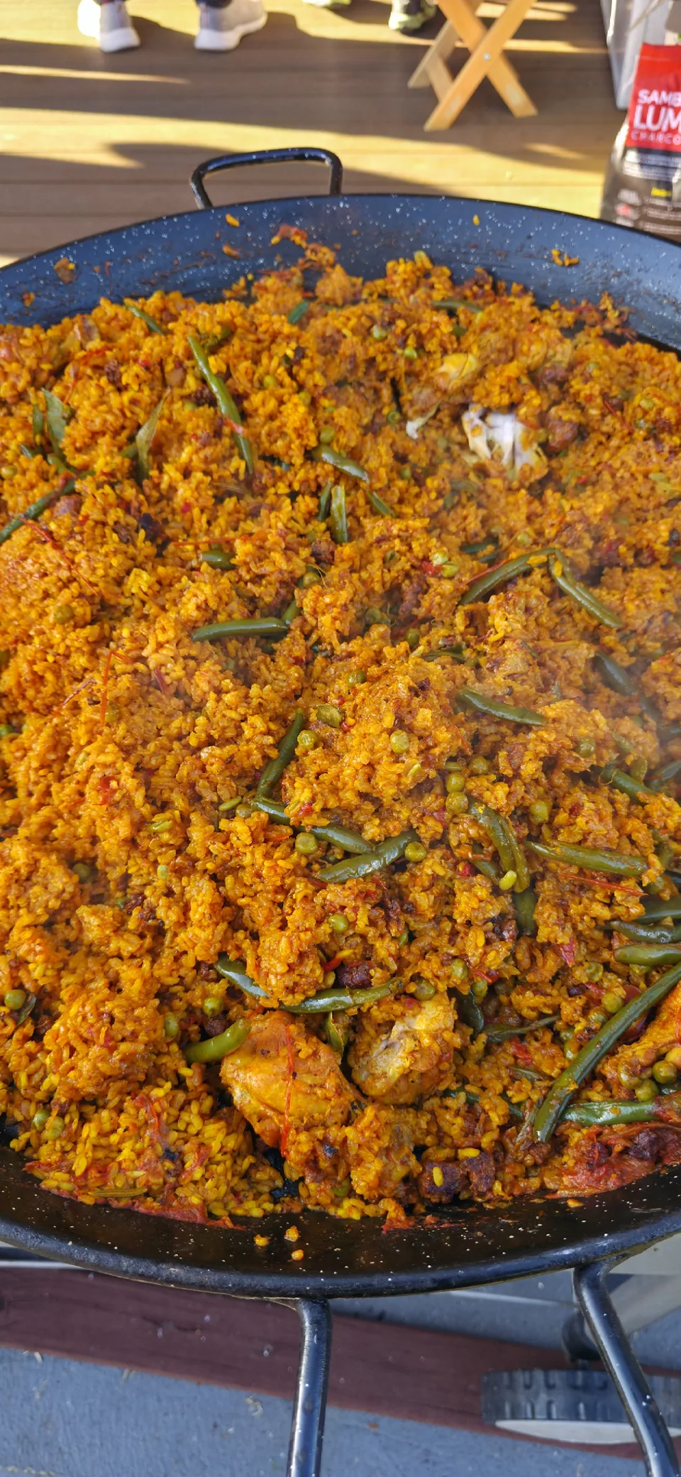 Close view of golden paella rice with chicken and green beans